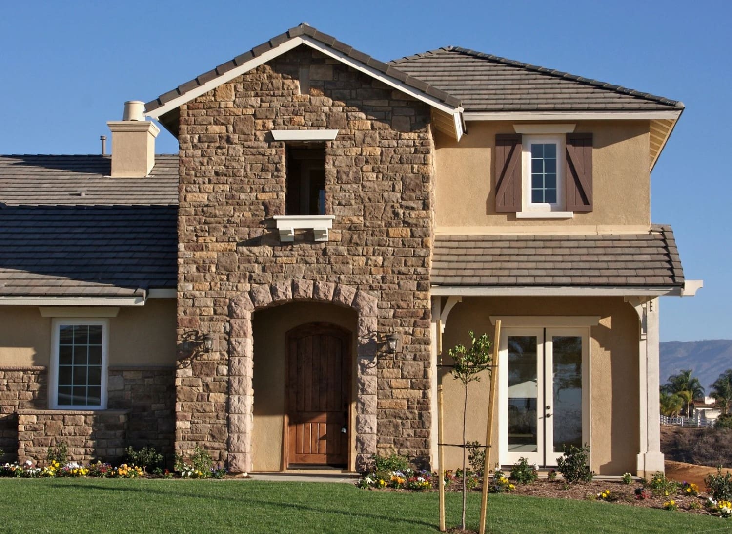 A large stone house with a brick front.